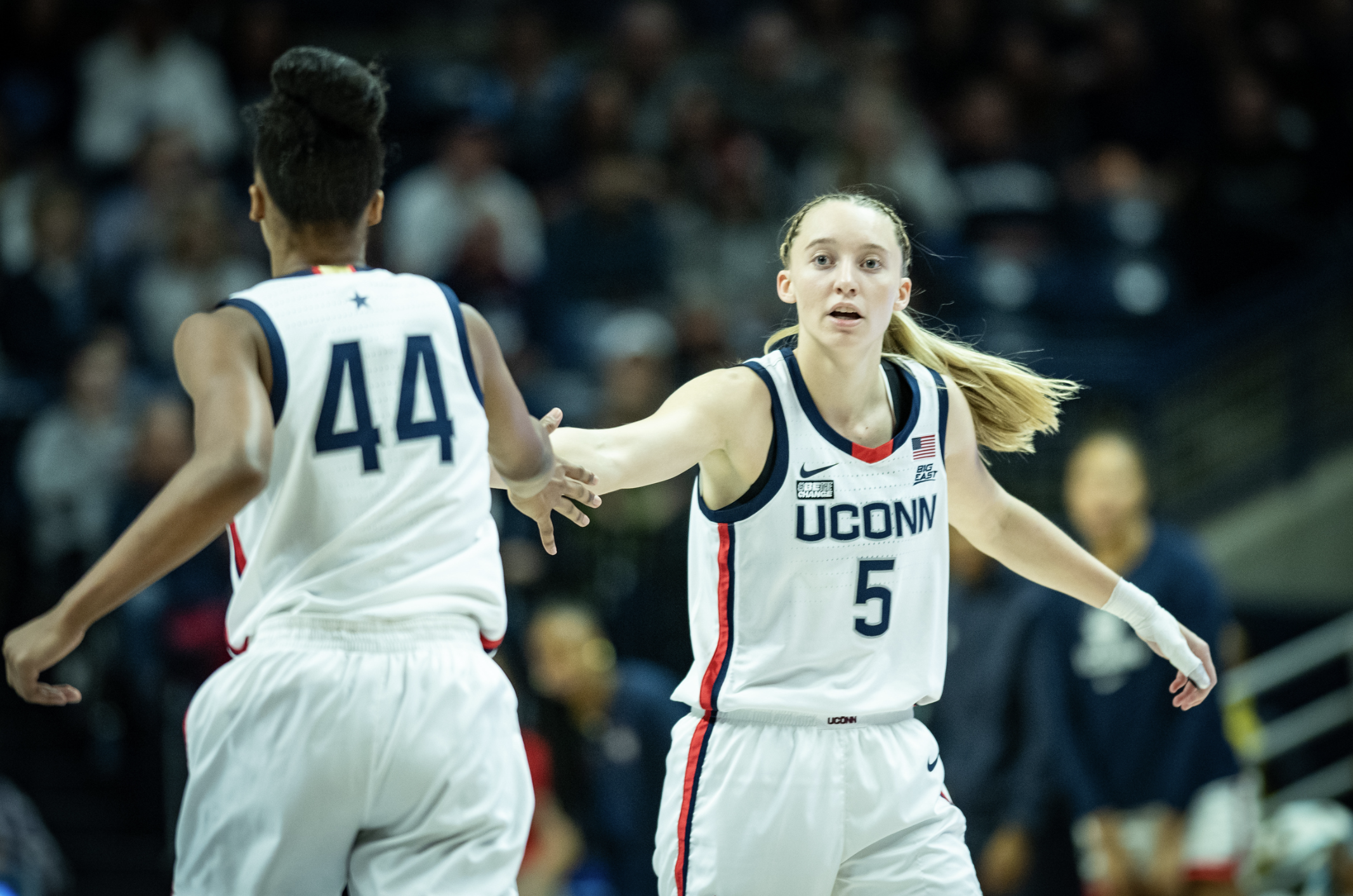Aubrey Griffin and Paige Bueckers give each other a high five during a game